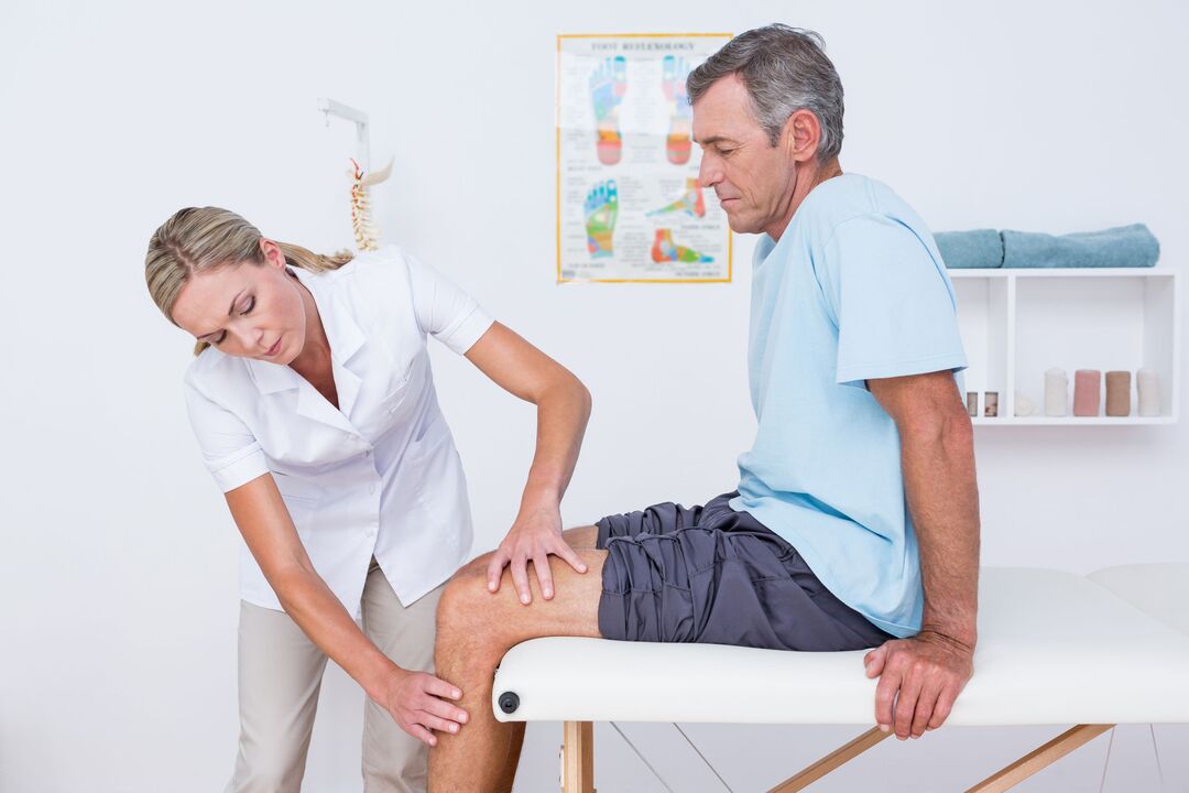 Doctor examining patient with knee joint disease